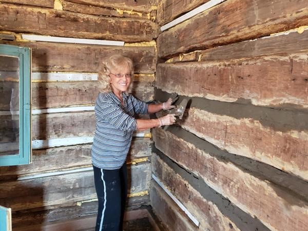Gloria Huhtala - one of the daughters chinking the cabin
